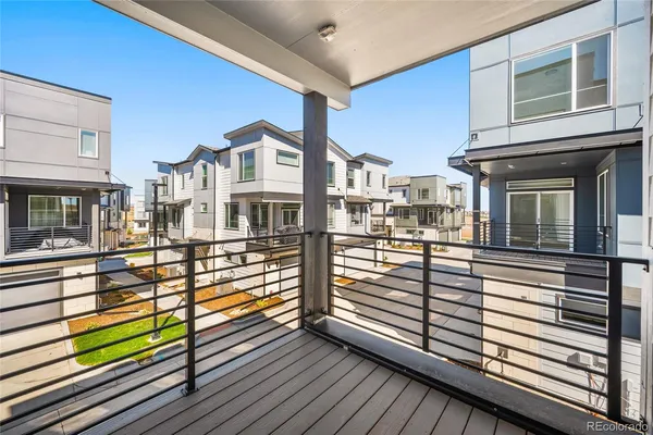 a view of a balcony with wooden floor and fence