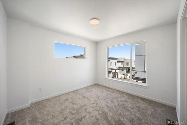 a view of a room with window and ceiling fan