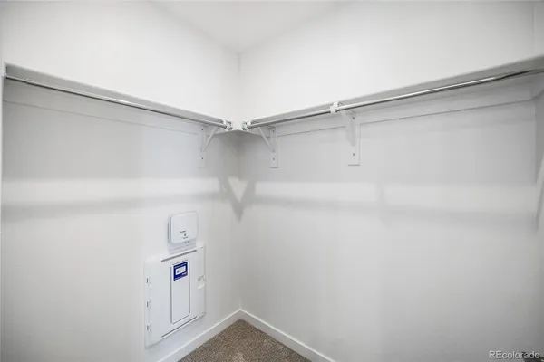 a view of storage and utility room with racks on the wall