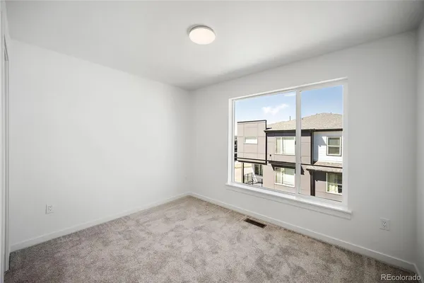 an empty room with windows and closet
