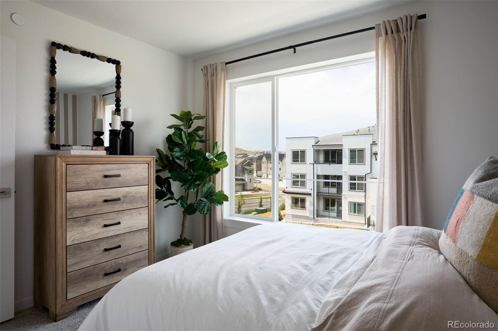 11964 Soprano Trail Lone Tree, CO 80134 - Photo 7 of 11 a bedroom with a bed and a dresser