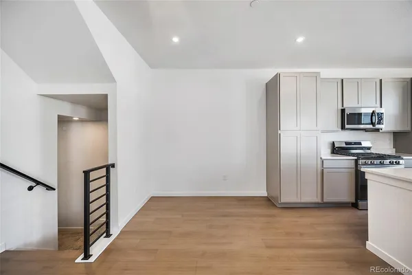 a view of a kitchen with a sink and a refrigerator