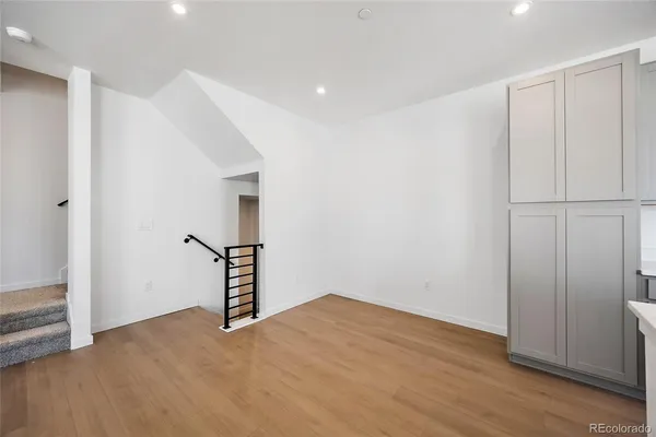 a view of an empty room with wooden floor