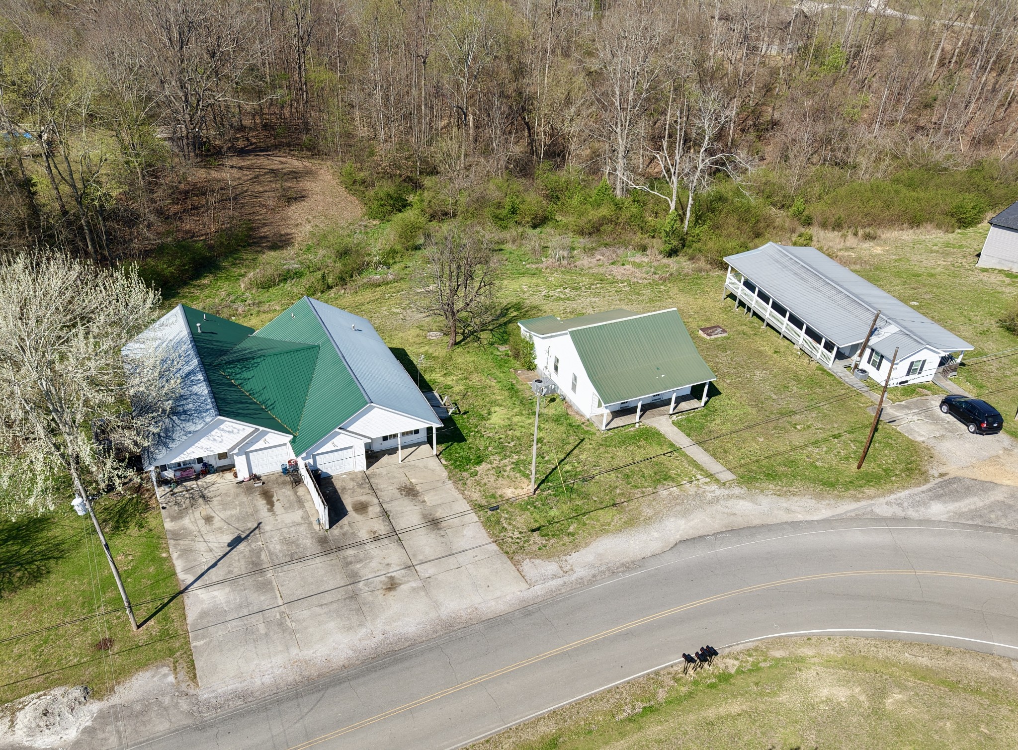 an aerial view of a house with a yard and lake