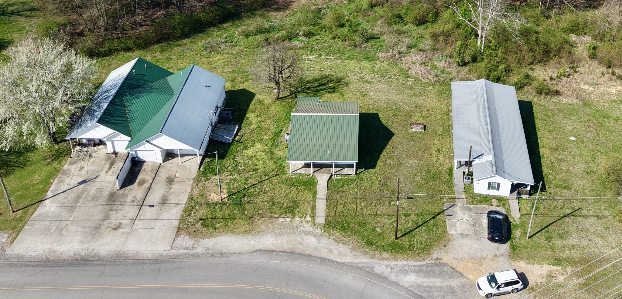 1431 Old Charlotte Road White Bluff, TN 37187 - Photo 5 of 8 an aerial view of a house with a garden and trees