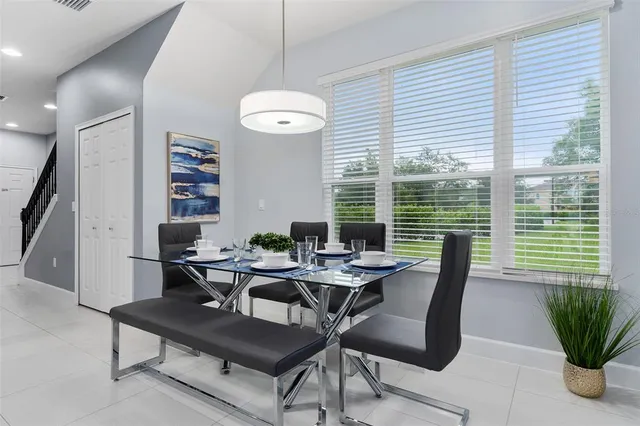 a view of a dining room with furniture window and outside view