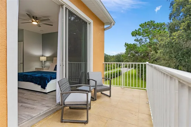 a balcony with furniture and a potted plant