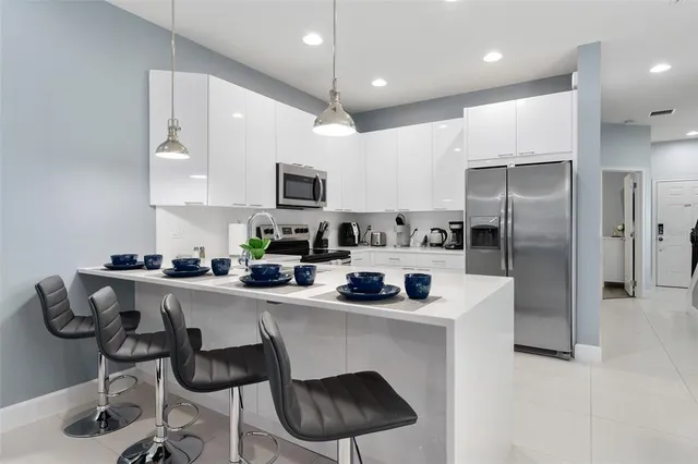 a kitchen with stainless steel appliances a sink stove and refrigerator