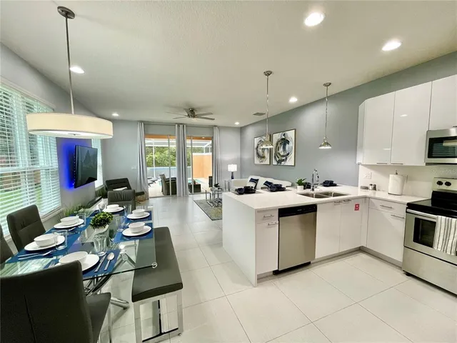a kitchen with sink refrigerator and microwave