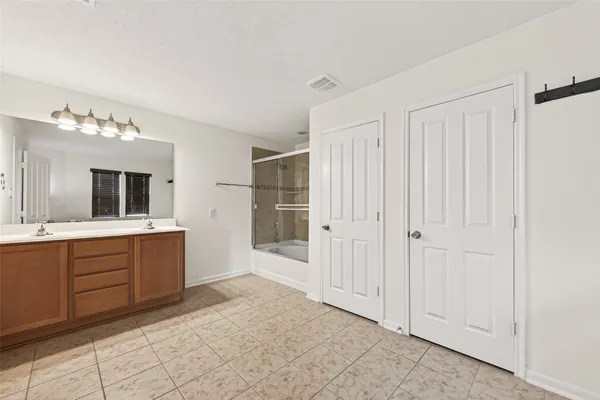 a large bathroom with a sink and a mirror
