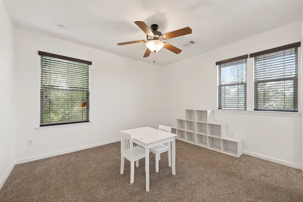 a dining room with furniture and window