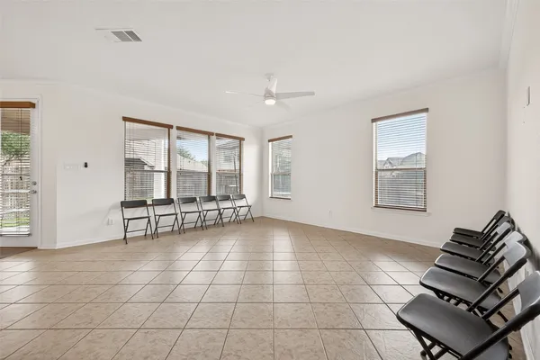 a view of a livingroom with lounge chair and a window