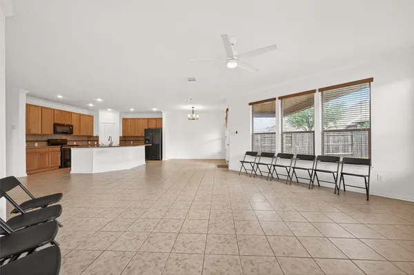 a view of empty room with wooden floor and furniture