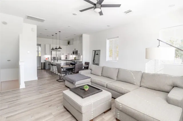 a living room with furniture and a wooden floor