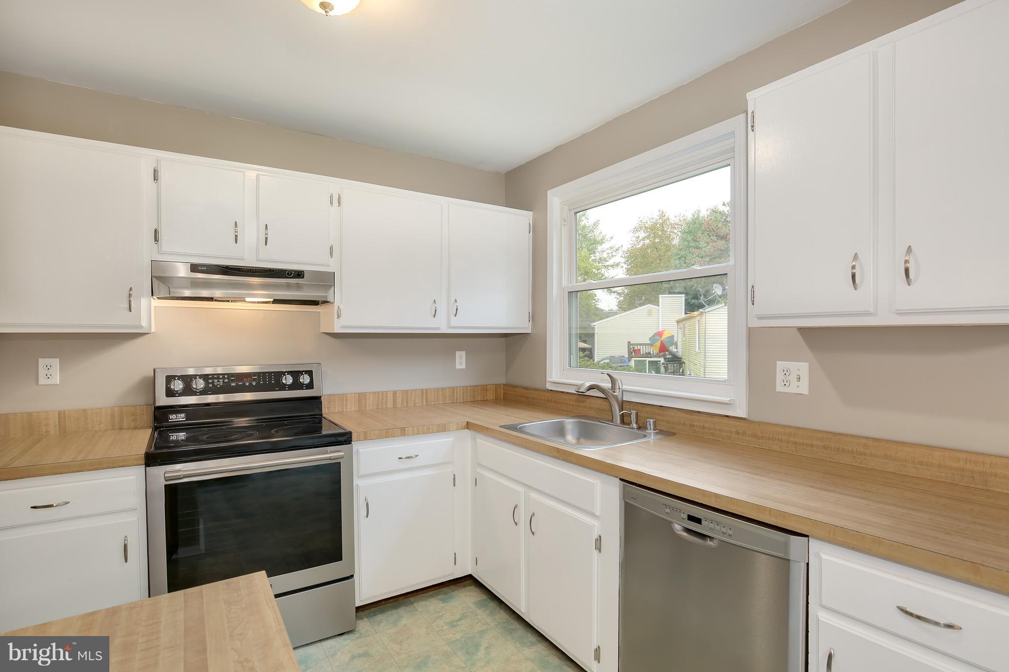 100 Applecreek Road Frederick, MD 21702 - Photo 17 of 30 a kitchen with cabinets appliances a sink and a window