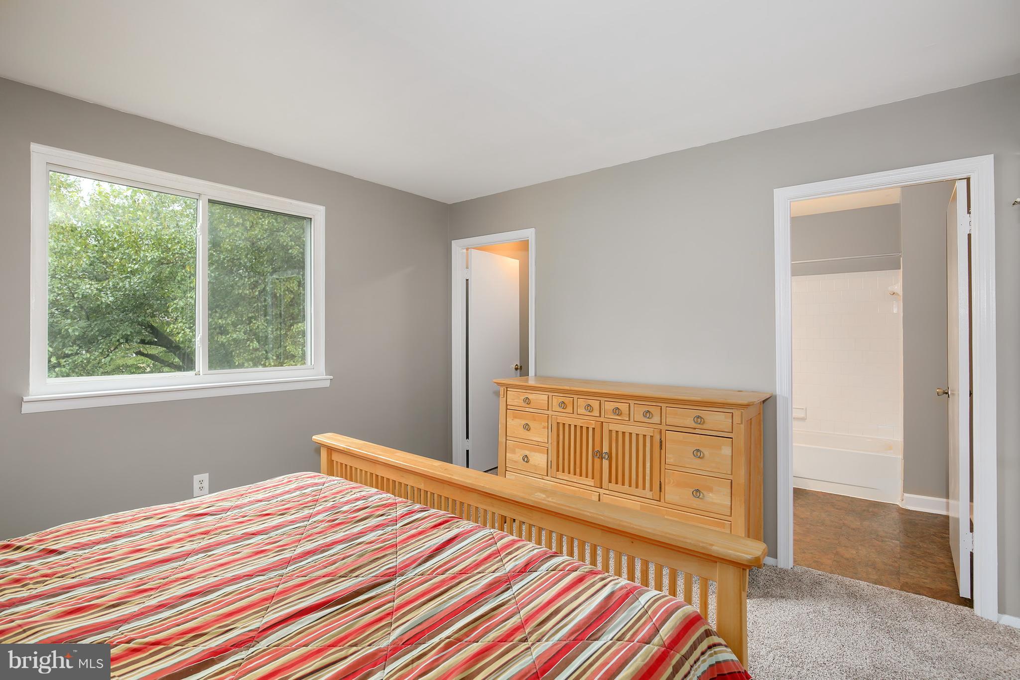 100 Applecreek Road Frederick, MD 21702 - Photo 20 of 30 a bedroom with a bed and wooden floor