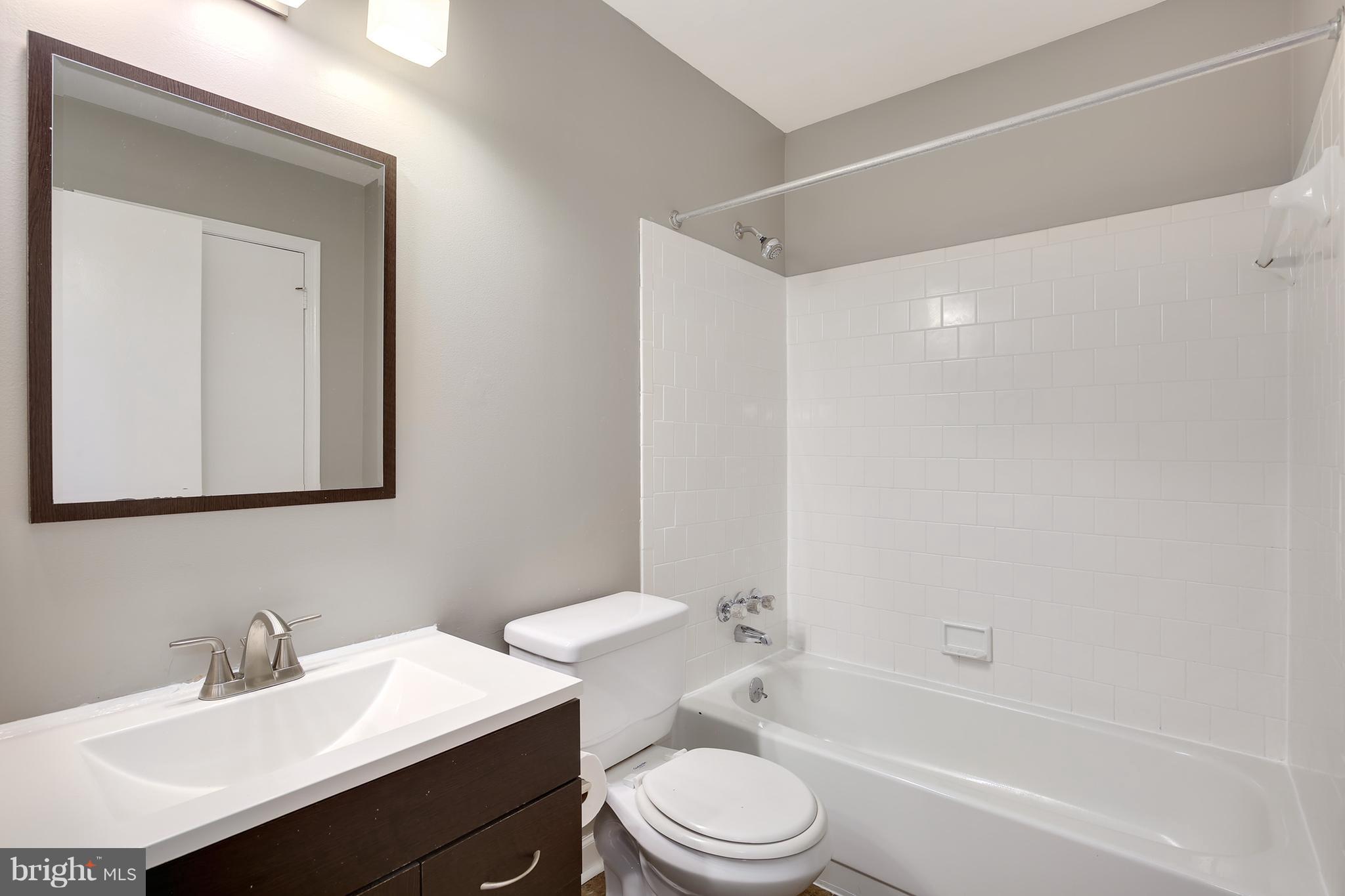 100 Applecreek Road Frederick, MD 21702 - Photo 24 of 30 a bathroom with a bathtub shower sink vanity mirror and toilet