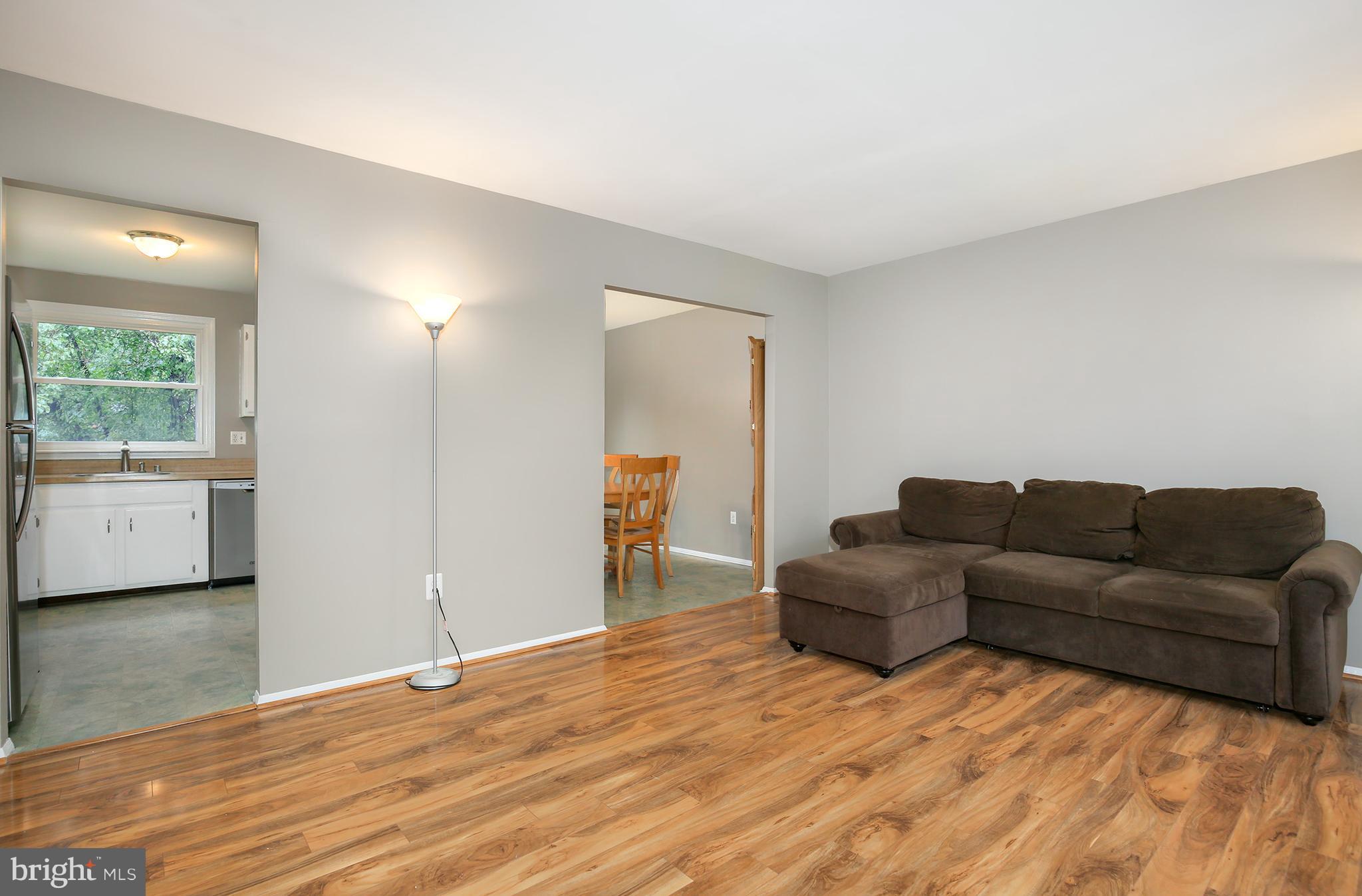 100 Applecreek Road Frederick, MD 21702 - Photo 6 of 30 a living room with a couch and a dresser next to a window