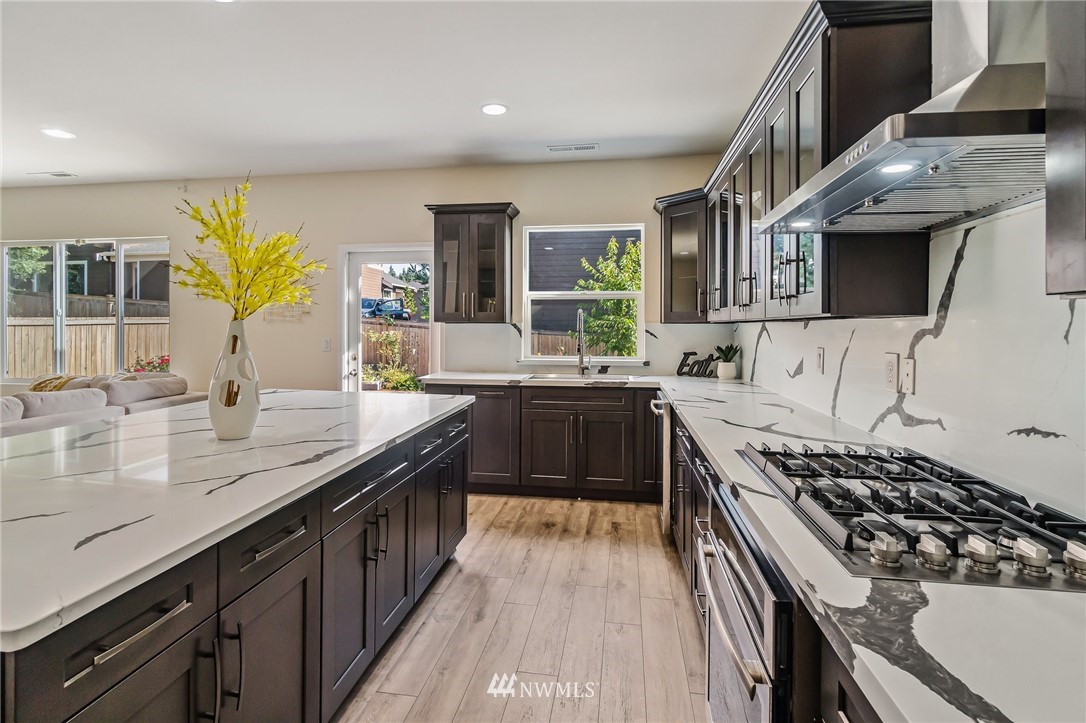 4122 167th Place Southeast Bothell, WA 98012 - Photo 14 of 40 a kitchen with a sink stove and cabinets