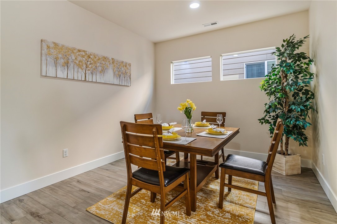 4122 167th Place Southeast Bothell, WA 98012 - Photo 16 of 40 a view of a dining room with furniture and wooden floor