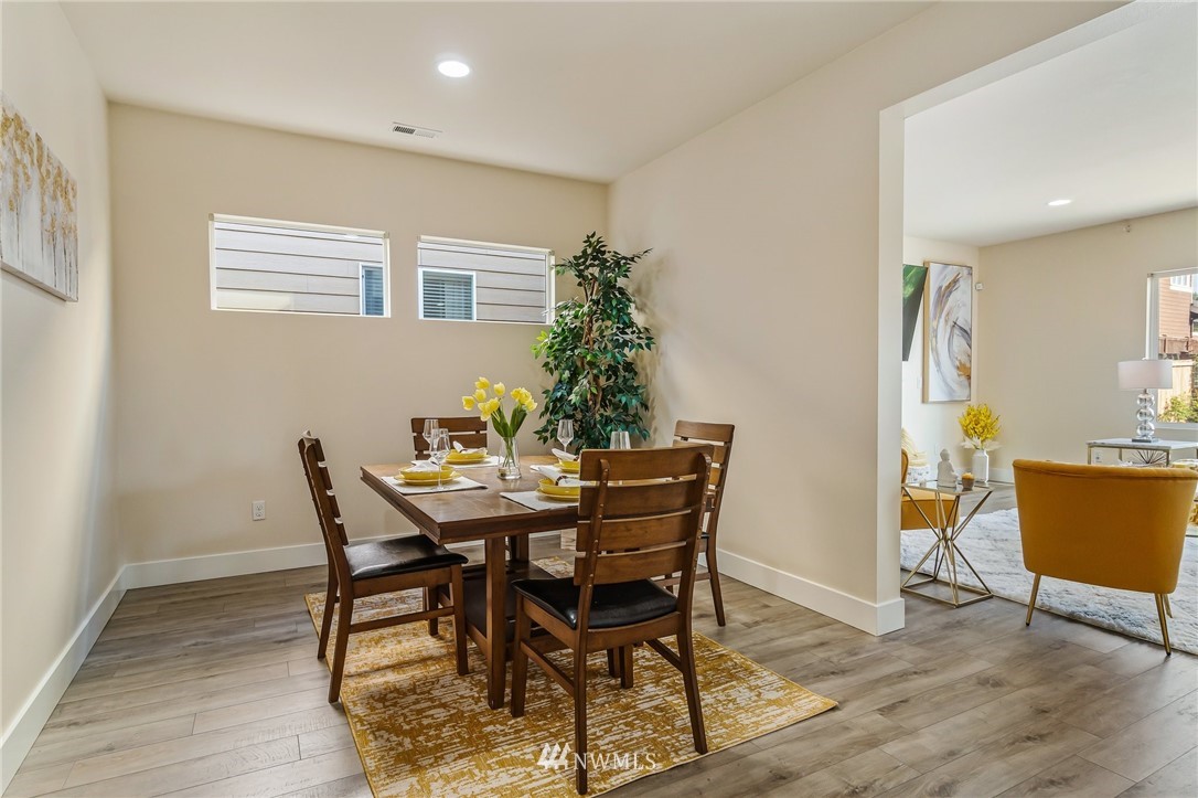 4122 167th Place Southeast Bothell, WA 98012 - Photo 17 of 40 a view of a dining room with furniture and wooden floor