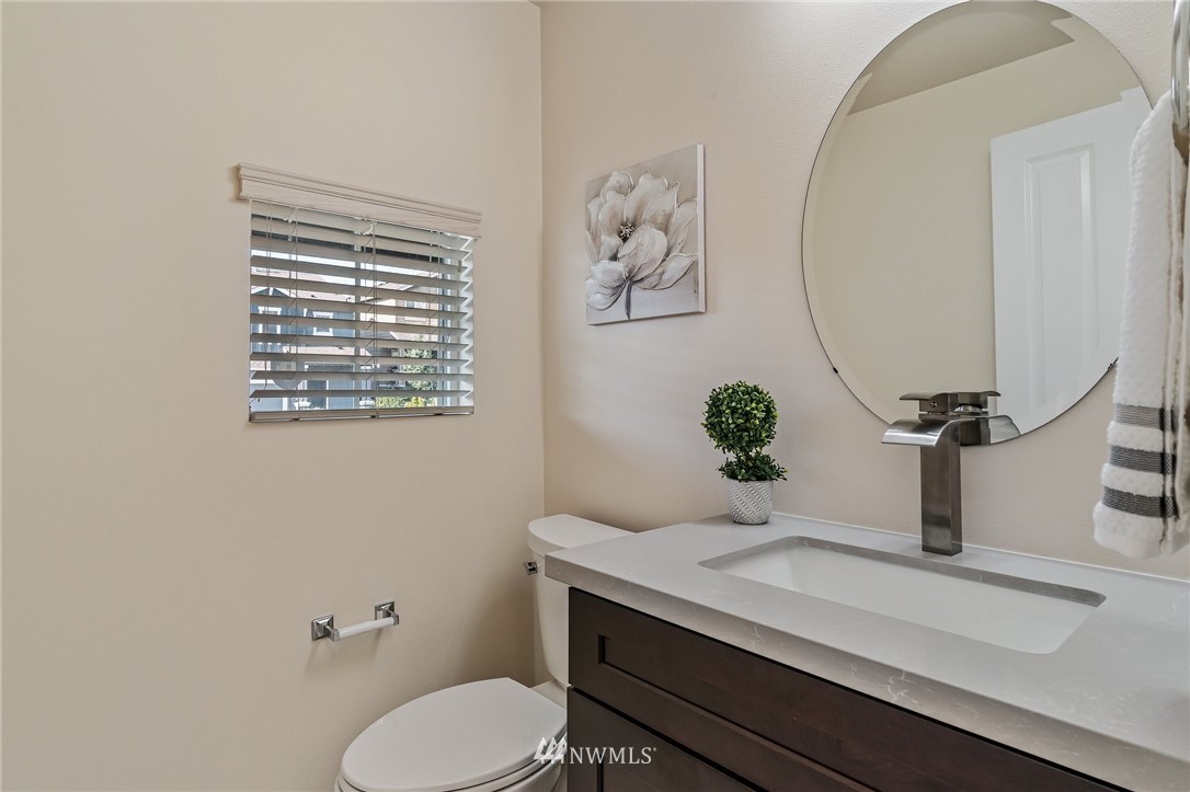 4122 167th Place Southeast Bothell, WA 98012 - Photo 18 of 40 a bathroom with a toilet sink and mirror