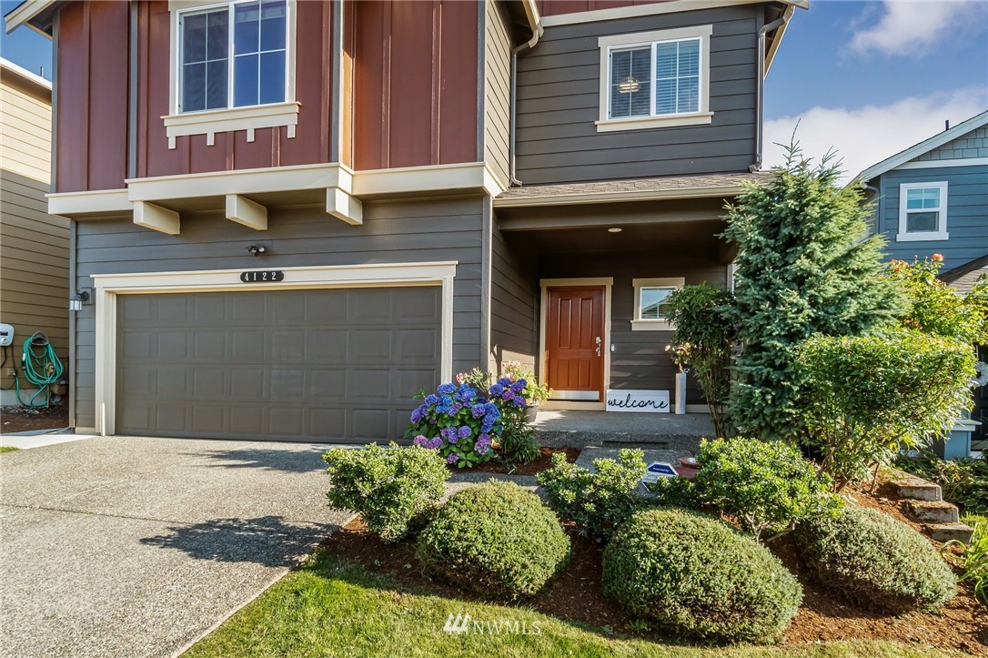 4122 167th Place Southeast Bothell, WA 98012 - Photo 3 of 40 a front view of a house with a yard and garage