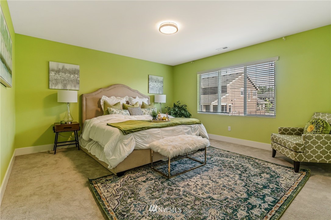 4122 167th Place Southeast Bothell, WA 98012 - Photo 22 of 40 a bed sitting in a spacious bedroom next to a window