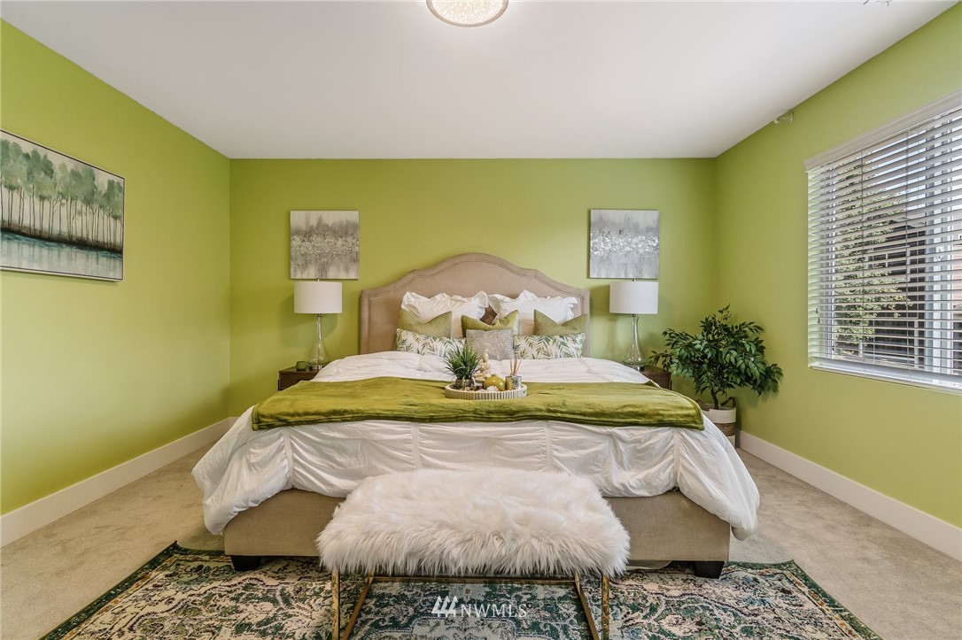 4122 167th Place Southeast Bothell, WA 98012 - Photo 23 of 40 a bed sitting in a bedroom next to a window