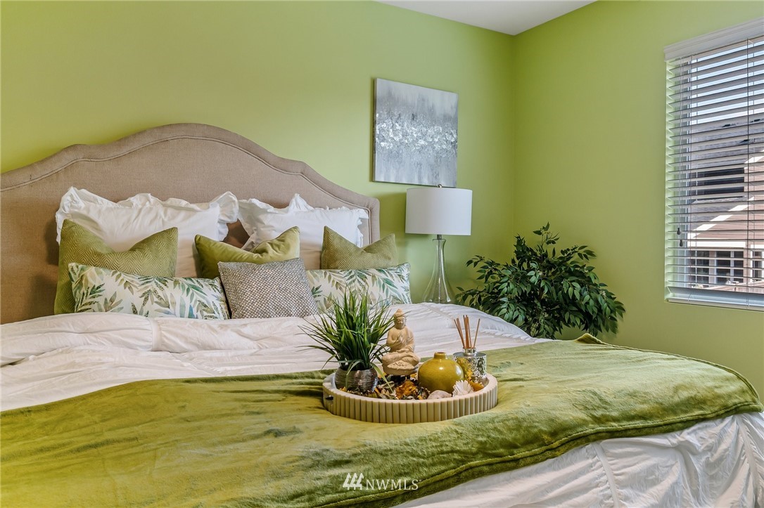 4122 167th Place Southeast Bothell, WA 98012 - Photo 24 of 40 a bed sitting in a bedroom next to a window and a potted plant
