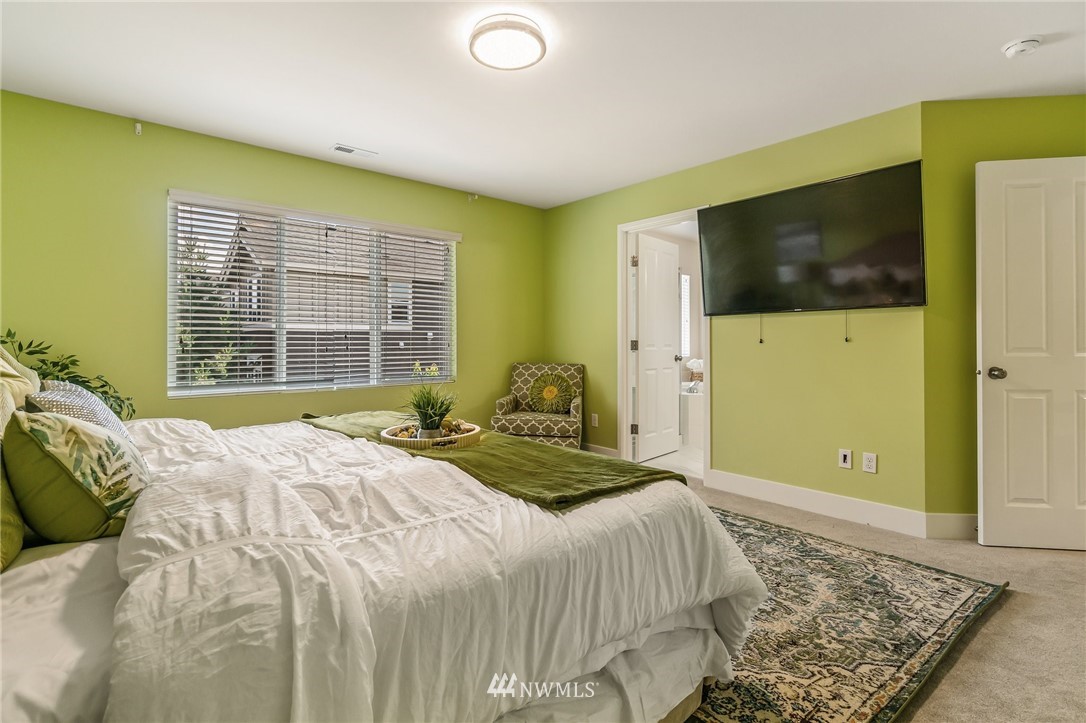 4122 167th Place Southeast Bothell, WA 98012 - Photo 25 of 40 a bedroom with a bed and a flat screen tv