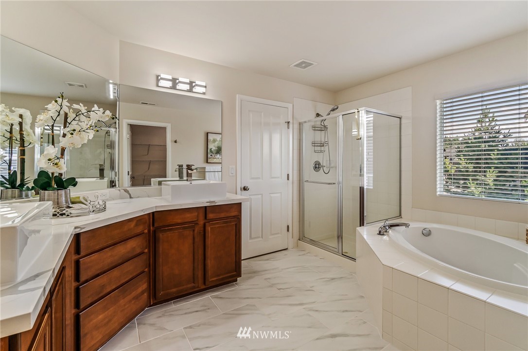 4122 167th Place Southeast Bothell, WA 98012 - Photo 26 of 40 a spacious bathroom with a bathtub shower sink double and mirror