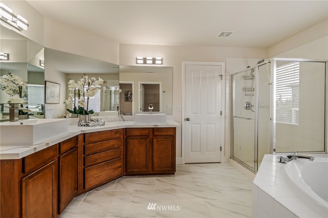 4122 167th Place Southeast Bothell, WA 98012 - Photo 27 of 40 a spacious bathroom with a double vanity sink shower and a mirror