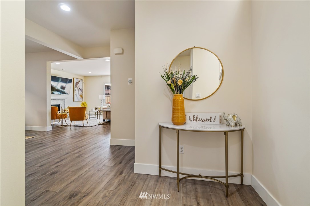 4122 167th Place Southeast Bothell, WA 98012 - Photo 4 of 40 a view of a room that has a bench and wooden floor