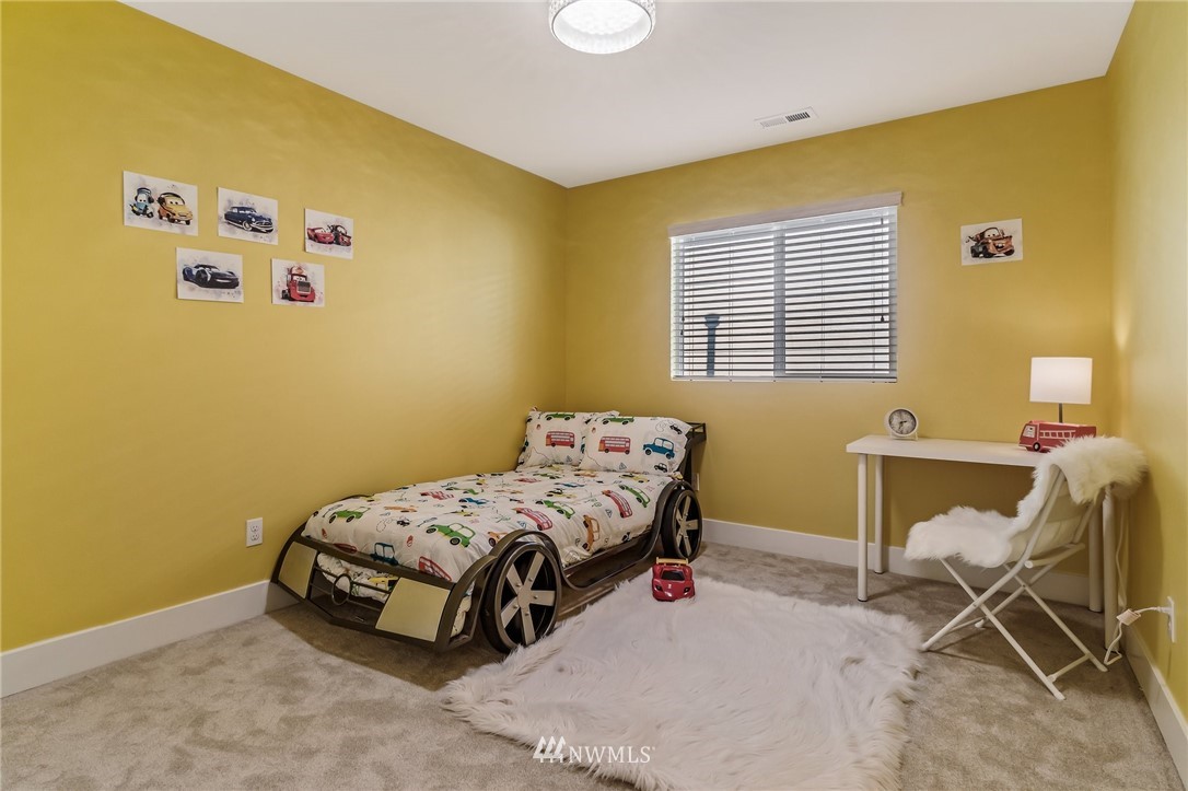 4122 167th Place Southeast Bothell, WA 98012 - Photo 34 of 40 a bedroom with a bed and a window