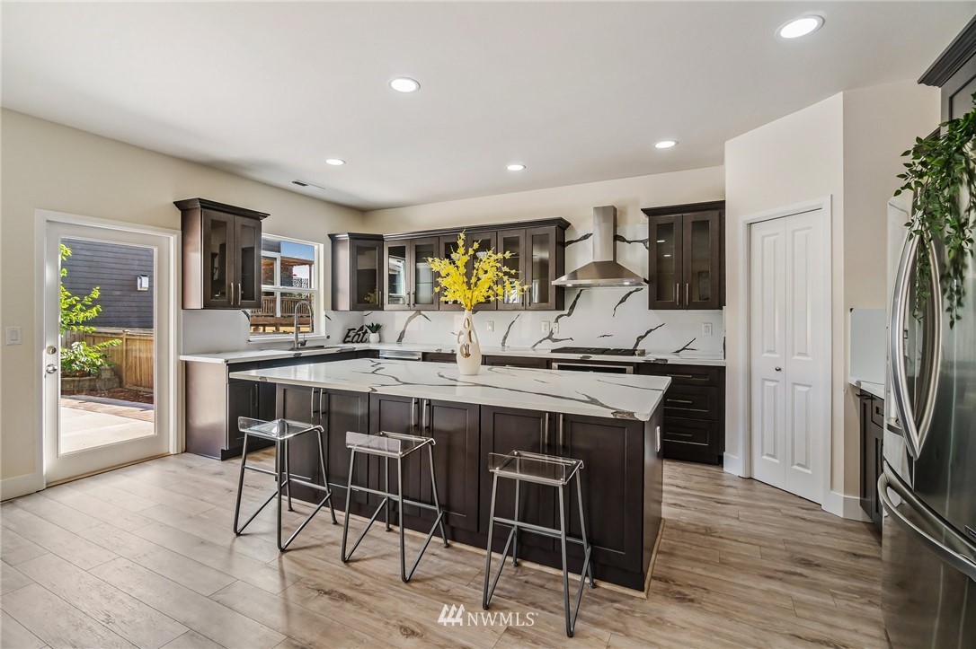 4122 167th Place Southeast Bothell, WA 98012 - Photo 10 of 40 a view of a dining room with furniture and wooden floor