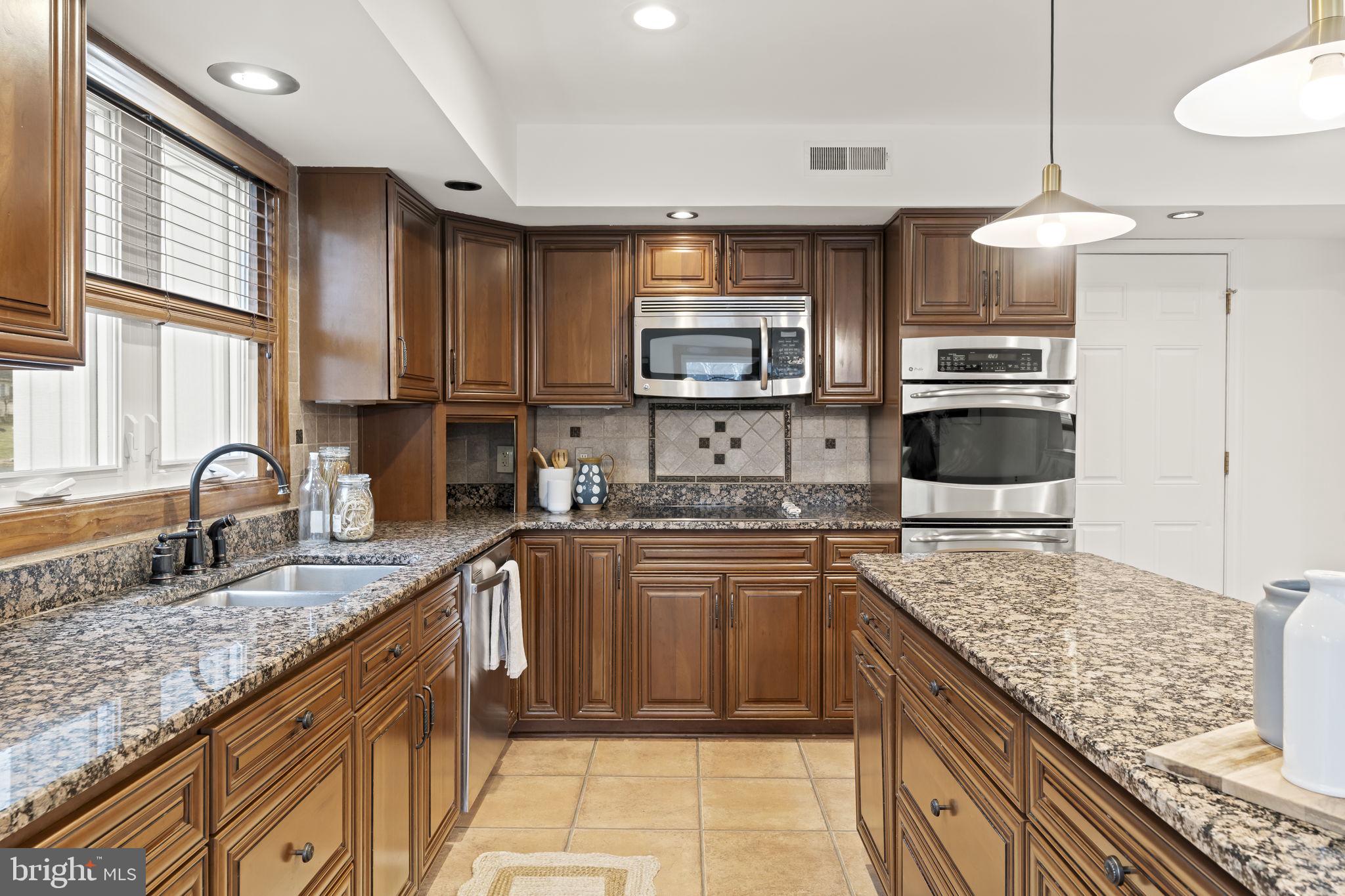 49 Langstoon Lane Media, PA 19063 - Photo 18 of 64 a kitchen with stainless steel appliances granite countertop a sink stove and refrigerator