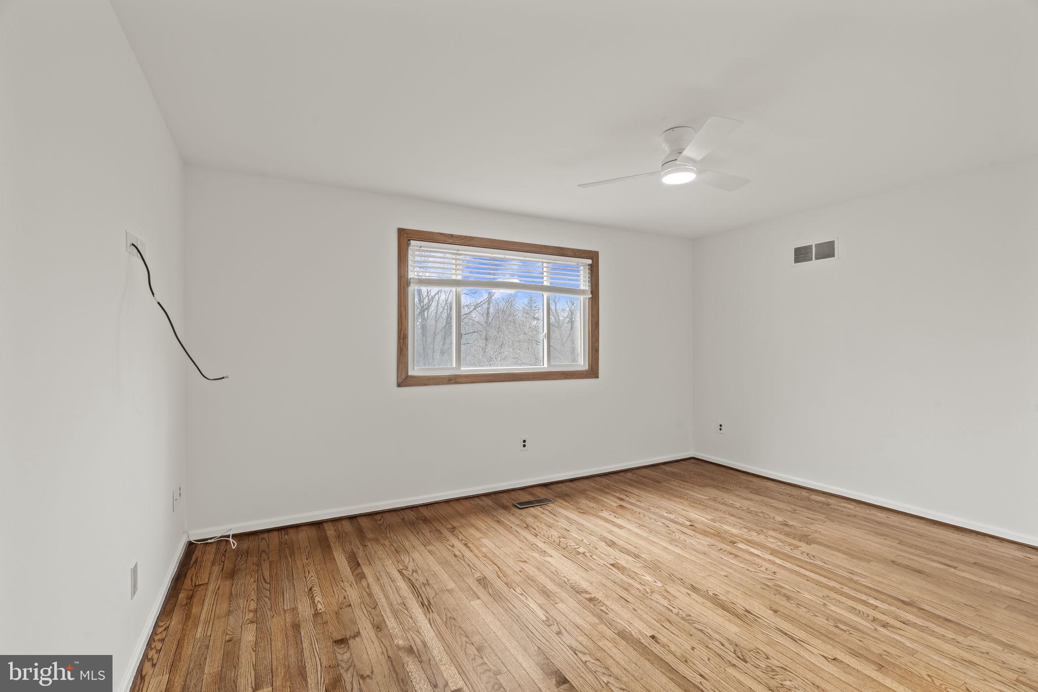 49 Langstoon Lane Media, PA 19063 - Photo 35 of 64 a view of empty room with wooden floor and fan