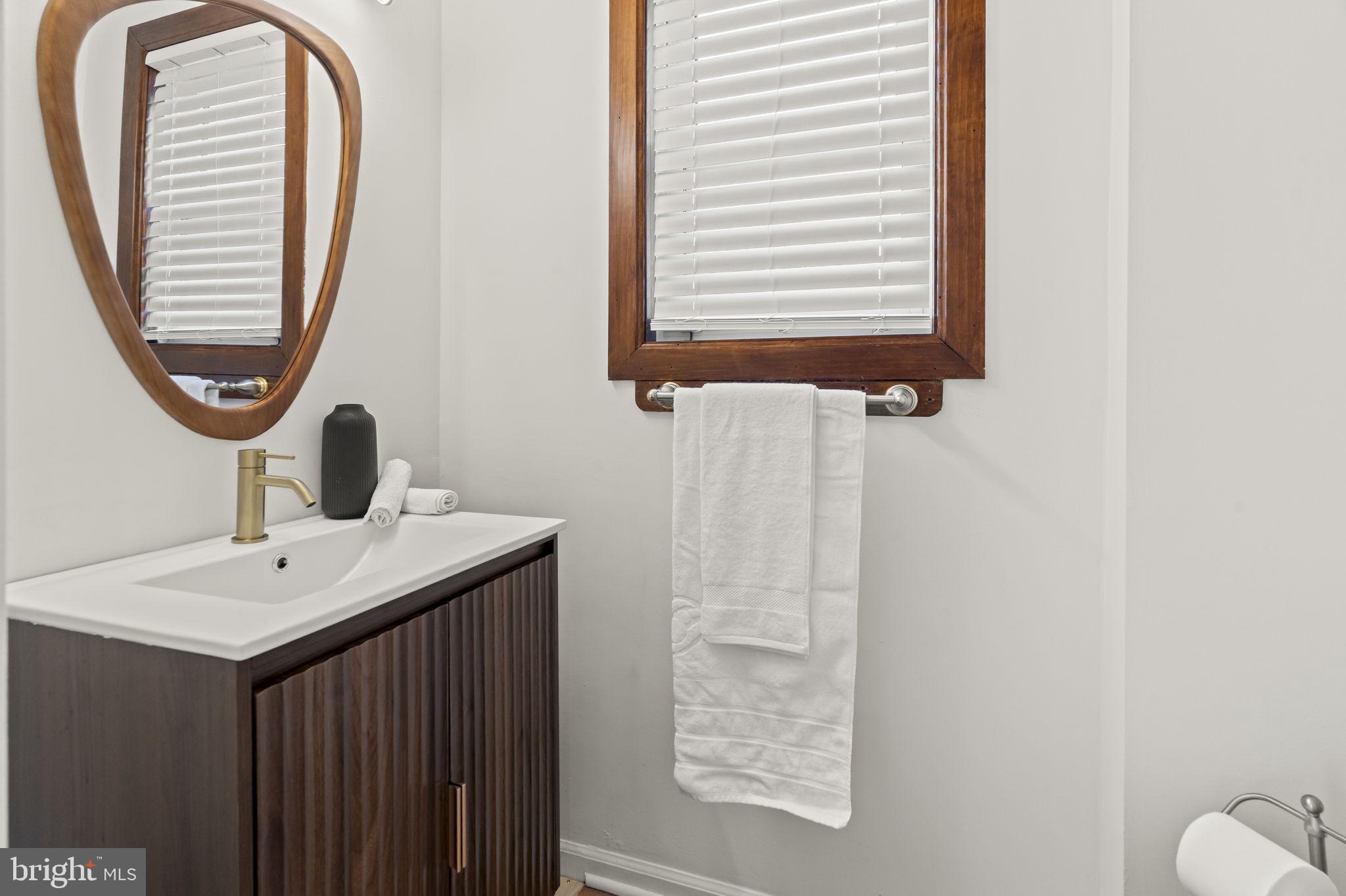 49 Langstoon Lane Media, PA 19063 - Photo 4 of 64 a bathroom with a sink and a mirror