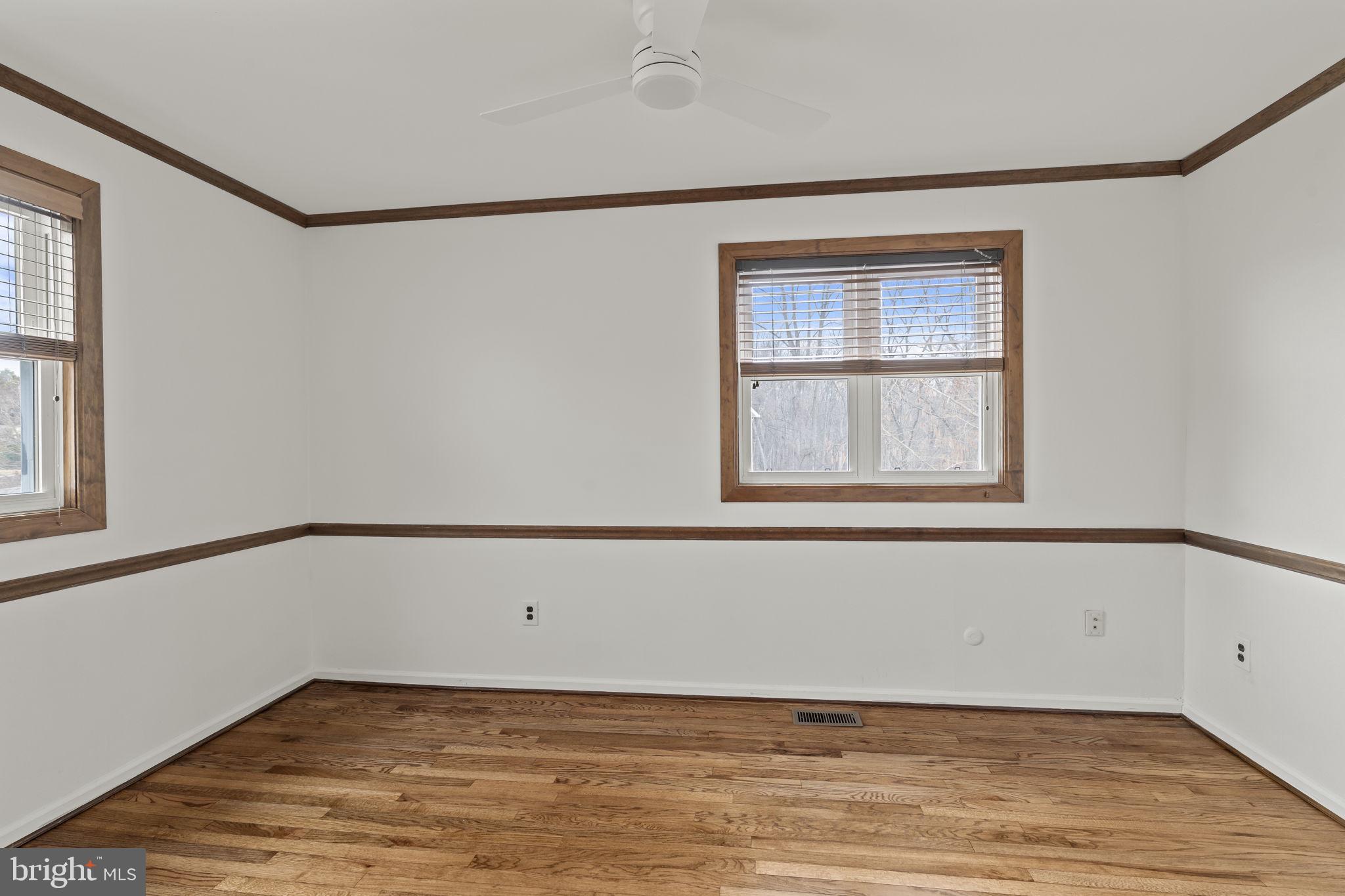 49 Langstoon Lane Media, PA 19063 - Photo 41 of 64 a view of an empty room with wooden floor and a window