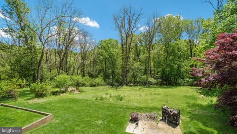 a backyard of a house with table and chairs