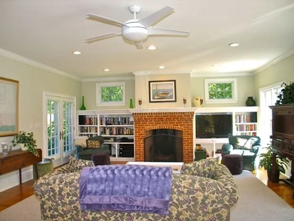 a living room with furniture a fireplace and a flat screen tv