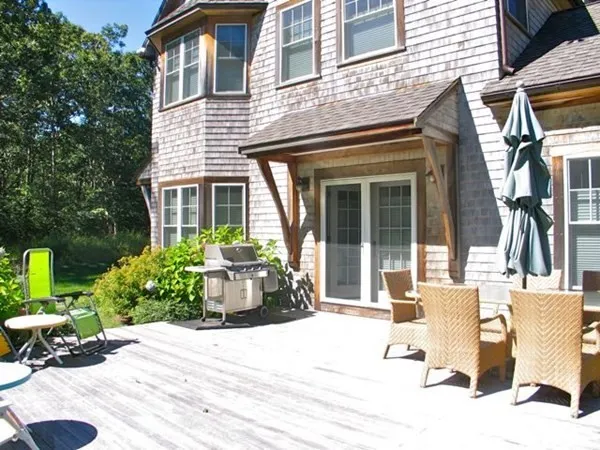 a view of a house with backyard and sitting area