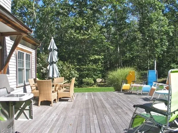 a balcony with furniture and wooden floor
