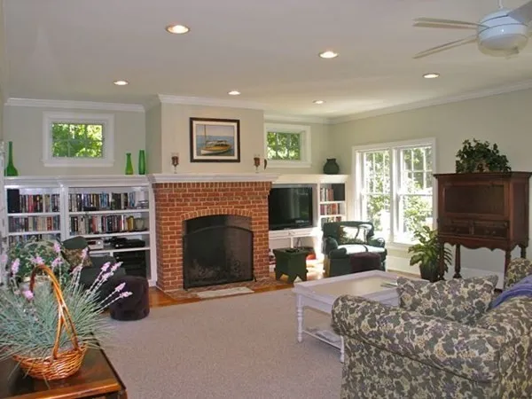 a living room with furniture a flat screen tv and a fireplace