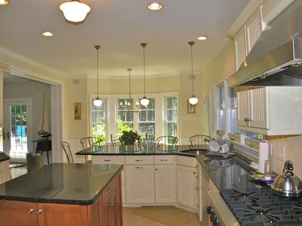 a kitchen with counter top space a sink and appliances
