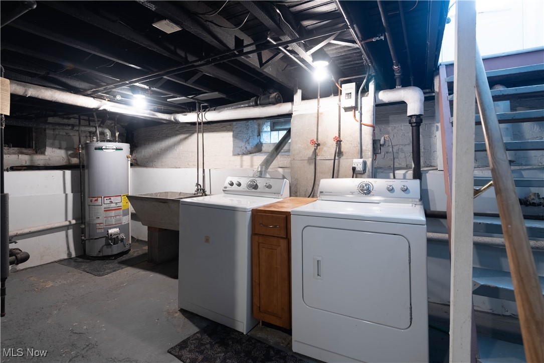 7003 Brecksville Road Independence, OH 44131 - Photo 29 of 35 Laundry area featuring concrete floors, water heater, and washing machine and clothes dryer