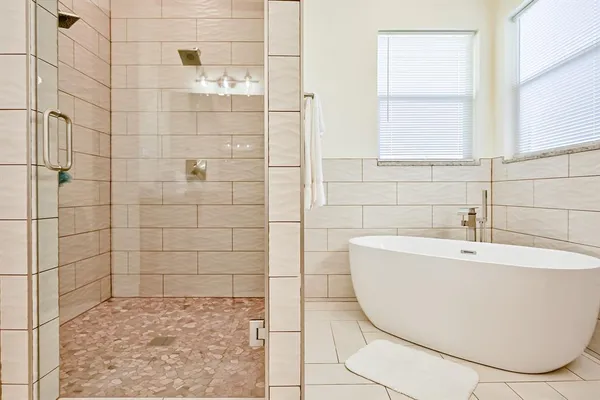 a bathroom with a bathtub and shower
