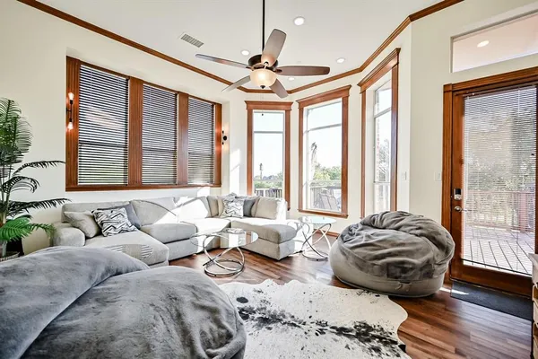 a living room with furniture and large windows