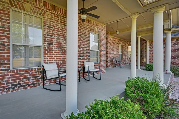 a view of a patio with table and chairs and potted plants